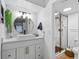Bright white bathroom with a modern vanity, mirror, and glass-enclosed shower at 2485 Lakeway Branch Dr # 2105, Orlando, FL 32839