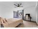 Comfortable bedroom features a ceiling fan, natural light from the window, and a cozy rug at 2485 Lakeway Branch Dr # 2105, Orlando, FL 32839