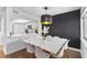 Stylish dining area featuring a modern light fixture, adjacent to the kitchen at 2485 Lakeway Branch Dr # 2105, Orlando, FL 32839