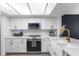 Contemporary kitchen featuring stainless steel appliances, white cabinets, and sleek countertops at 2485 Lakeway Branch Dr # 2105, Orlando, FL 32839