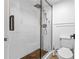 Modern glass enclosed shower with wood floor panel and wall mounted fixture at 2485 Lakeway Branch Dr # 2105, Orlando, FL 32839