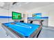 Bright game room featuring a pool table, foosball table, and two large screen TVs at 2496 Rama Dr, Kissimmee, FL 34746