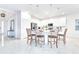 Open kitchen with white countertops, stainless steel appliances, an island with seating, and marble floors at 2496 Rama Dr, Kissimmee, FL 34746