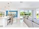 Open-concept living area with counter seating and views of the screened patio and pool at 2496 Rama Dr, Kissimmee, FL 34746