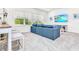 Bright living room with a large window, comfortable couch, and a mounted TV at 2496 Rama Dr, Kissimmee, FL 34746