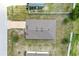 Aerial view of the property showcasing the roof, driveway, and surrounding landscaping at 257 Fig Ct, Kissimmee, FL 34759