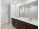 Bathroom with double sink vanity, large mirror, and shower at 257 Fig Ct, Kissimmee, FL 34759