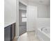 Bright bathroom with soaking tub and open door to bedroom with natural light from window at 257 Fig Ct, Kissimmee, FL 34759