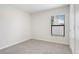 Cozy carpeted bedroom featuring bright window with ample light and white door at 257 Fig Ct, Kissimmee, FL 34759