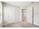 Bright carpeted bedroom featuring neutral walls with open doorway leading to the hallway at 257 Fig Ct, Kissimmee, FL 34759