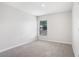 Cozy carpeted bedroom boasts natural light with a window showcasing backyard at 257 Fig Ct, Kissimmee, FL 34759