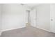 Carpeted bedroom featuring neutral walls and open doorway leading to the hallway at 257 Fig Ct, Kissimmee, FL 34759