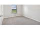 Carpeted bedroom offers neutral walls with window providing ample natural light at 257 Fig Ct, Kissimmee, FL 34759