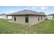 Rear exterior displaying the covered patio, windows, and siding, blending style and functionality at 257 Fig Ct, Kissimmee, FL 34759