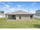Rear exterior view highlighting the covered patio and complementary design elements at 257 Fig Ct, Kissimmee, FL 34759