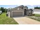 Beautiful home showcasing its attached two-car garage and well-maintained lawn at 257 Fig Ct, Kissimmee, FL 34759