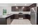 Well-equipped kitchen featuring stainless steel appliances, dark cabinets, and light countertops at 257 Fig Ct, Kissimmee, FL 34759