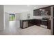 Modern kitchen with stainless steel appliances, granite counters, and tiled flooring at 257 Fig Ct, Kissimmee, FL 34759