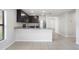 Open kitchen with granite countertops, stainless steel refrigerator, and view of the adjacent living area at 257 Fig Ct, Kissimmee, FL 34759