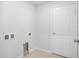 Utility room with hook ups and tile floor, with access door at 257 Fig Ct, Kissimmee, FL 34759