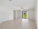 Spacious living room with tile flooring and sliding glass door, bathed in natural light at 257 Fig Ct, Kissimmee, FL 34759