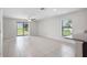 Bright living room with sliding glass doors leading to the backyard and tile flooring at 257 Fig Ct, Kissimmee, FL 34759