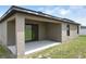 Exterior view of the covered patio featuring a seamless transition from indoor to outdoor living space at 257 Fig Ct, Kissimmee, FL 34759