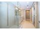 Elegant bathroom featuring a glass-enclosed shower, double vanity, and neutral tile flooring and accents at 260 S Osceola Ave # 710, Orlando, FL 32801