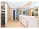 Elegant bathroom with walk-in shower, double vanity, and direct access to the walk-in closet at 260 S Osceola Ave # 710, Orlando, FL 32801