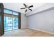 Spacious bedroom with large window, ceiling fan, and neutral carpet providing a relaxing atmosphere at 260 S Osceola Ave # 710, Orlando, FL 32801