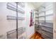 Organized walk-in closet with steel shelving and wood floors, designed for optimal storage and easy access at 260 S Osceola Ave # 710, Orlando, FL 32801