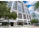 Modern high-rise exterior featuring sleek architecture, multiple balconies, and lush landscaping at 260 S Osceola Ave # 710, Orlando, FL 32801