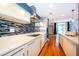 Modern kitchen with sleek white cabinets, stainless steel appliances and wooden floors at 260 S Osceola Ave # 710, Orlando, FL 32801