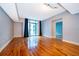 Spacious living room featuring a balcony, wood floors, and neutral paint at 260 S Osceola Ave # 710, Orlando, FL 32801