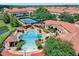 Aerial view of a community pool, tennis courts, and lush landscaping at 2704 Lobelia Dr, Lake Mary, FL 32746