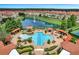 Aerial view of the community pool area with cabanas, seating, manicured landscaping, and a lake with fountain at 2704 Lobelia Dr, Lake Mary, FL 32746