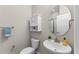 Compact bathroom featuring a vessel sink, round mirror, and storage cabinet at 2704 Lobelia Dr, Lake Mary, FL 32746