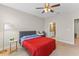 Spacious bedroom with plush carpet, a ceiling fan, and an en-suite bathroom, creating a private retreat at 2704 Lobelia Dr, Lake Mary, FL 32746