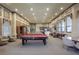 Spacious game room featuring a pool table, comfortable seating, and a kitchenette for entertaining guests at 2704 Lobelia Dr, Lake Mary, FL 32746