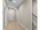 Hallway features neutral walls, access to multiple rooms, as well as a staircase to the upper level of the home at 2704 Lobelia Dr, Lake Mary, FL 32746