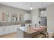 Open-concept kitchen with stainless steel appliances, granite countertops, an island, and white cabinets at 2704 Lobelia Dr, Lake Mary, FL 32746