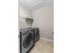 Modern laundry room featuring a side-by-side washer and dryer set for convenient laundry days at 2704 Lobelia Dr, Lake Mary, FL 32746