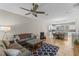 Spacious open-concept living room with stylish decor seamlessly connecting to the dining area and kitchen at 2704 Lobelia Dr, Lake Mary, FL 32746