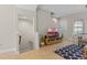 Living room featuring a staircase, a TV and entertainment center and an area rug at 2704 Lobelia Dr, Lake Mary, FL 32746
