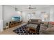 Living room with a comfortable sofa, TV, side tables, area rug and staircase access at 2704 Lobelia Dr, Lake Mary, FL 32746