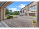 Townhome exterior showcasing attached garages, brick pavers, beautiful landscaping, and views of nearby green spaces at 2704 Lobelia Dr, Lake Mary, FL 32746
