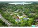 Aerial view of the home near a beautiful lake, surrounded by lush greenery, in a residential neighborhood at 300 Royal Palm Ct, Longwood, FL 32779