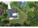 Aerial view of the home with a pool and a screened enclosure on a large lot surrounded by trees at 300 Royal Palm Ct, Longwood, FL 32779