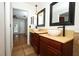 Bathroom featuring dual vanities with vessel sinks and modern fixtures at 300 Royal Palm Ct, Longwood, FL 32779
