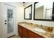 Bathroom featuring a granite double sink vanity and a view to the outside at 300 Royal Palm Ct, Longwood, FL 32779